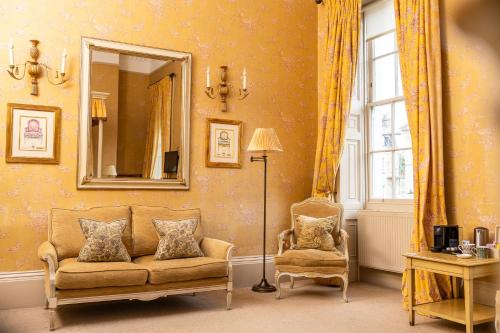 a living room with a couch and a mirror at Dukes Bath in Bath