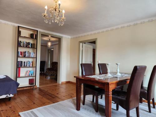 a dining room with a wooden table and chairs at Grafschaft in Jüterbog