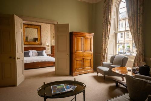 a living room with a bed and a table at Dukes Bath in Bath