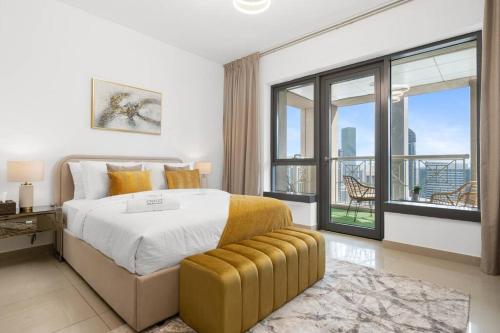 a bedroom with a large bed and a balcony at Chalet Homes Apartment Near Burj Khalifa and Dubai Mall in Dubai
