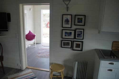 a kitchen with a wall with pictures on it at Hattvika Lodge in Ballstad