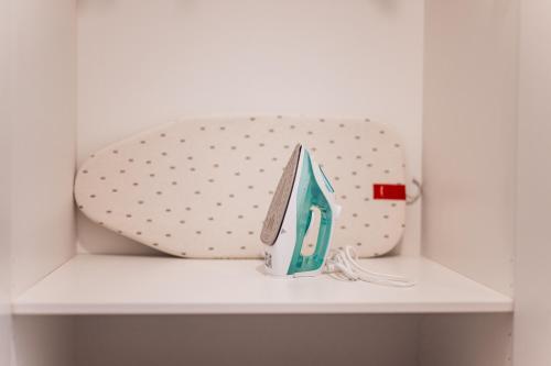 a white shelf with a bag on top of it at Rezidence Sadová Zlín in Zlín
