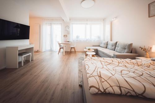 a living room with a bed and a couch at Rezidence Sadová Zlín in Zlín