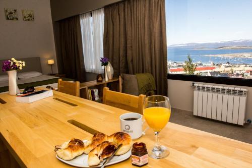 a table with a plate of food and a glass of orange juice at Miralejos in Ushuaia