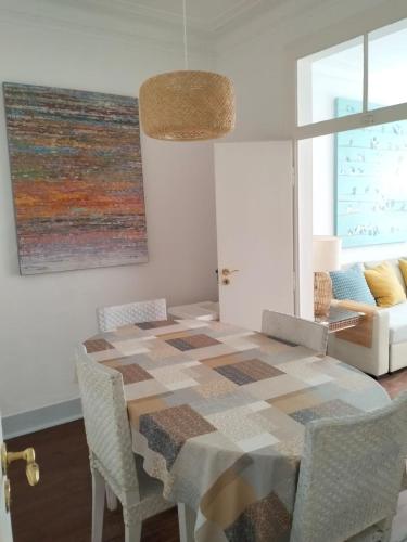 a dining room with a table and chairs at Bird's Nest Lisbon Apartment in Lisbon