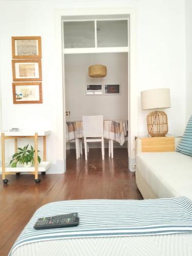 a living room with a couch and a table at Bird's Nest Lisbon Apartment in Lisbon