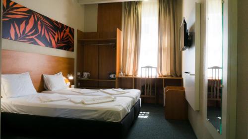 Arta City Hotelにあるベッド