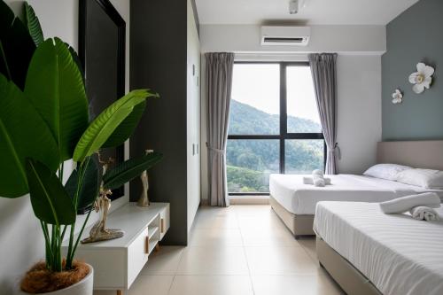 a bedroom with two beds and a large window at Family Suite Midhills Genting Highlands Free Wi-Fi in Genting Highlands
