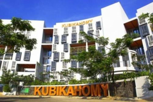 a large white building with a sign on it at natural minimalist apt ice bsd in Cilandak