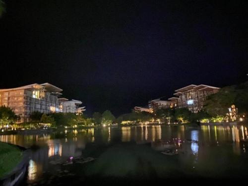 a view of a lake at night with buildings at Jacana B 603 at Pico de Loro by Raquel's Place in Cutad