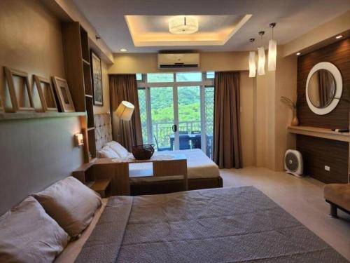 a hotel room with a large bed and a desk at Jacana B 603 at Pico de Loro by Raquel's Place in Cutad