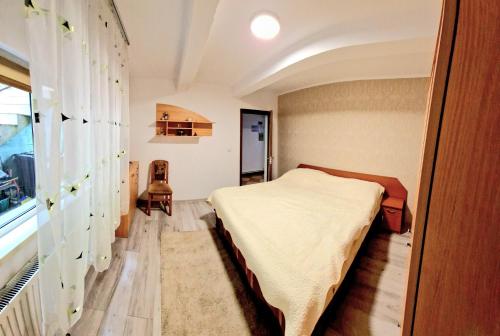 a bedroom with a bed in the corner of a room at Casa Kati in Buşteni