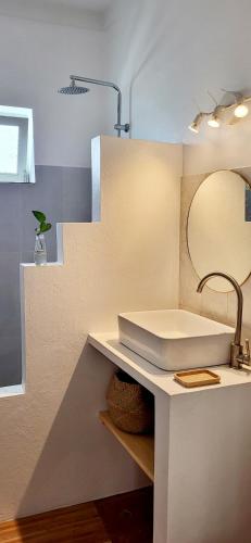 a bathroom with a sink and a mirror at Surfhouse Boavista in Sal Rei
