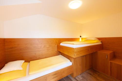 a small room with two beds in it at Seehaus Winkler in Weissensee