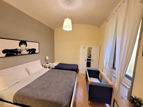 a small bedroom with a bed and a chair at Home Vaticano 50 steps from Museum in Rome