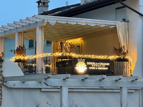 a porch with christmas lights and a sign on it at Dimora di Charme Rooms & Apartments in Peschiera del Garda