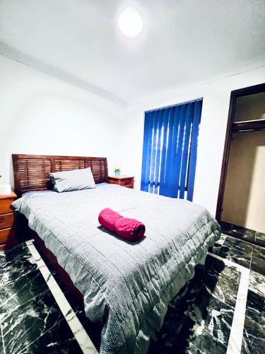 a bedroom with a bed with a red pillow on it at Long Term Stay FiFO Queen Size Bedroom Near Sawn River City Fremantle University in Perth