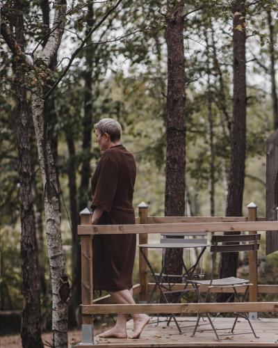 a man walking past a bench in a park at Smålandstorpets lanthotell in Hok