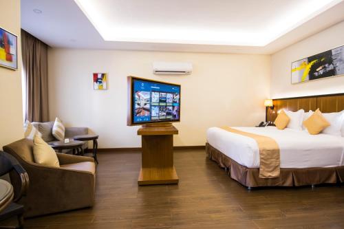 a hotel room with a bed and a flat screen tv at Belad Bont Resort in Salalah