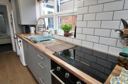 a kitchen with a counter with a stove top oven at New Bilton House in Rugby