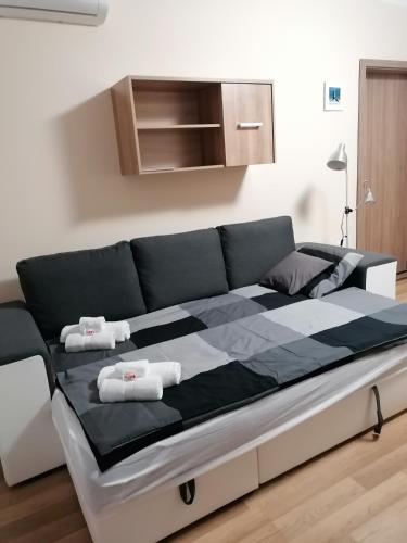 a large black and white bed in a room at Central Park Apartman in Szekszárd