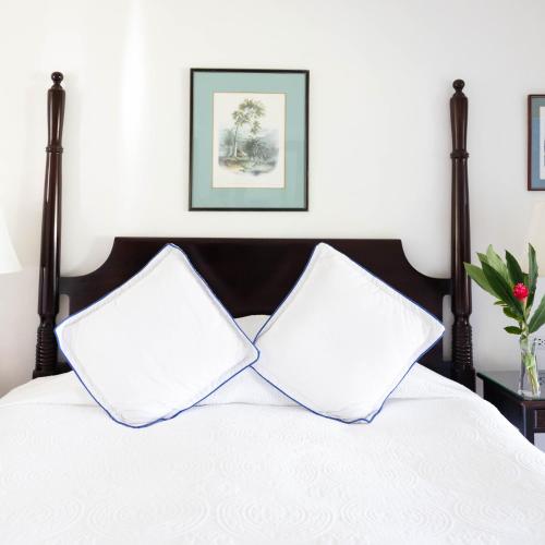 two pillows sitting on top of a bed at Jamaica Inn in Ocho Rios