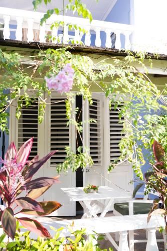 a white picnic table in front of a white house at Jamaica Inn in Ocho Rios