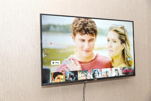 a flat screen tv hanging on a wall at Eirini Elegant - Hermes Apartment in Midrand