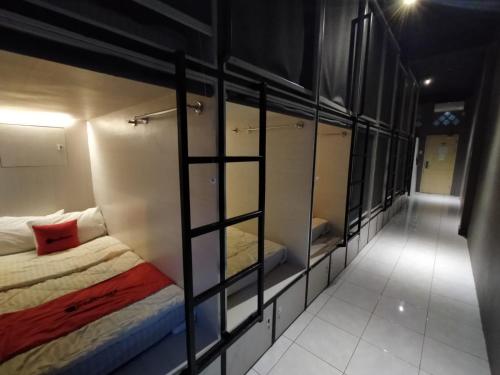 a room with a bed and some glass walls at Banda Capsule in Banda Aceh
