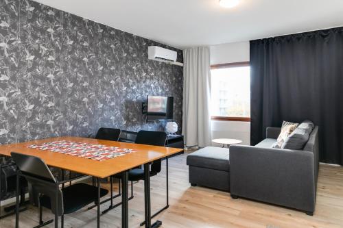 a living room with a table and a couch at Santa's Holiday Homes in Rovaniemi