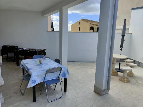 a table with a blue table cloth on it in a room at Sicilia bedda in Custonaci