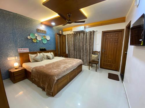 a bedroom with a bed and a television in it at AL-MANAL 203 Luxury Suite Rooms 3BHK in Bhatkal