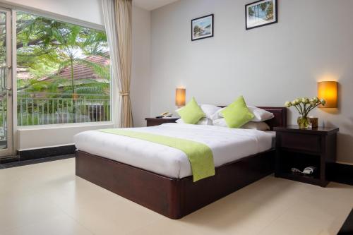 a bedroom with a bed and a large window at Skyline Boutique Hotel in Phnom Penh