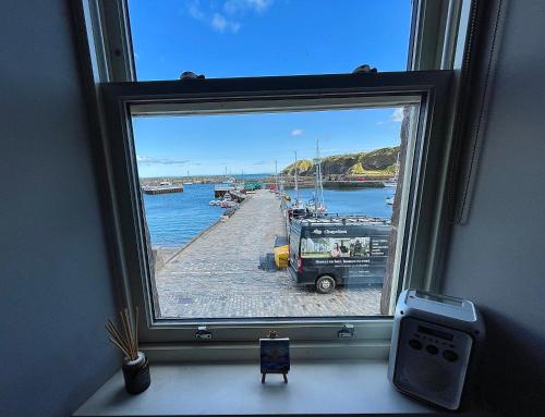 a window with a view of a marina at Shorehead Guest House in Stonehaven