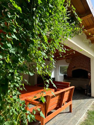 a wooden bench sitting in front of a brick fireplace at Villa Rivus in Sarajevo