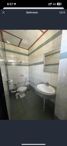 a bathroom with a sink and a toilet at Dung Fang Hotel in Kapit