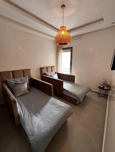 a living room with two beds and a couch at Anza Blue in Agadir