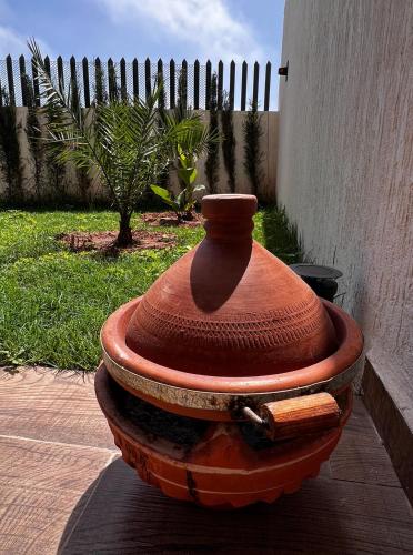 a vase sitting on top of a fire hydrant at Anza Blue in Agadir
