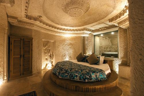 a bedroom with a bed in a large room at Harem Suites Cappadocia in Uchisar