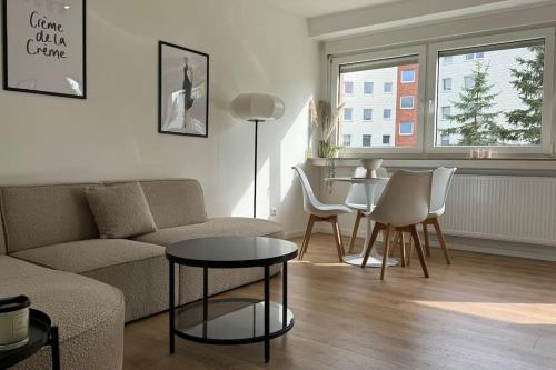 a living room with a couch and a table at Cozy apartment with balcony in Lehre