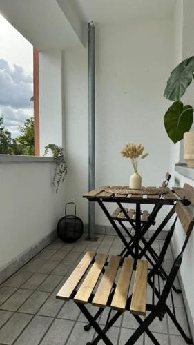 a table and a bench sitting on a balcony at Cozy apartment with balcony in Lehre