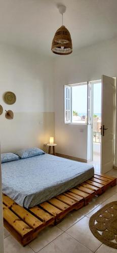 a bedroom with a bed made out of pallets at Surfhouse Boavista in Sal Rei