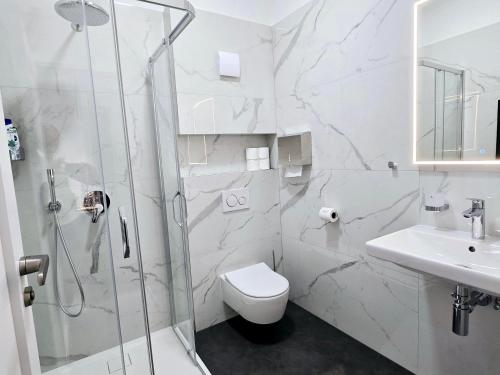 a bathroom with a shower and a toilet and a sink at Salón MISSEN in Trenčianske Teplice