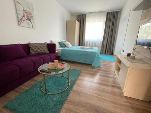 a living room with a couch and a table at Happy M&S 2 in Šabac