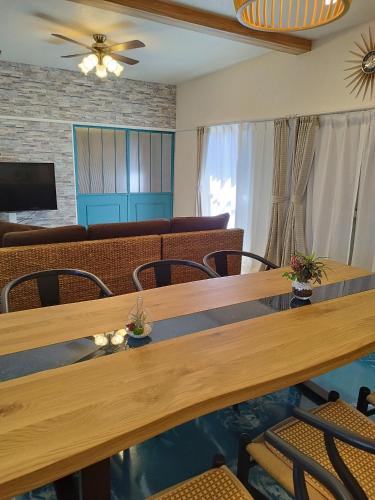 a dining room with a table and chairs at Breath of the Sea Katakai in Katakai