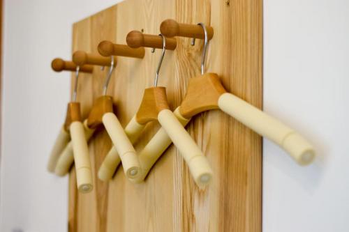 a bunch of wooden hangers on a wooden wall at Zhangjiajie Twelve Warm Inn-Tianmen Mountain Ropeway Station in Zhangjiajie