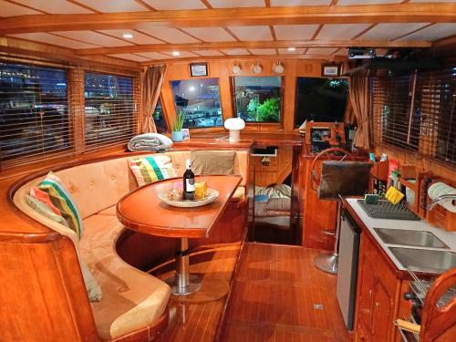 a kitchen with a table in a boat at Motorjacht At Ease in Amsterdam