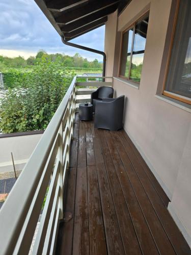 a balcony of a house with a chair and a window at Casetta Friulana in Udine