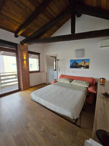 a bedroom with a large bed in a room at Casetta Friulana in Udine