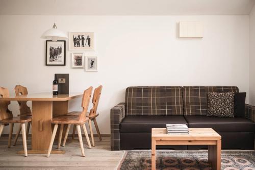 a living room with a couch and a table at Christophorus Mountain Residence in San Vigilio Di Marebbe